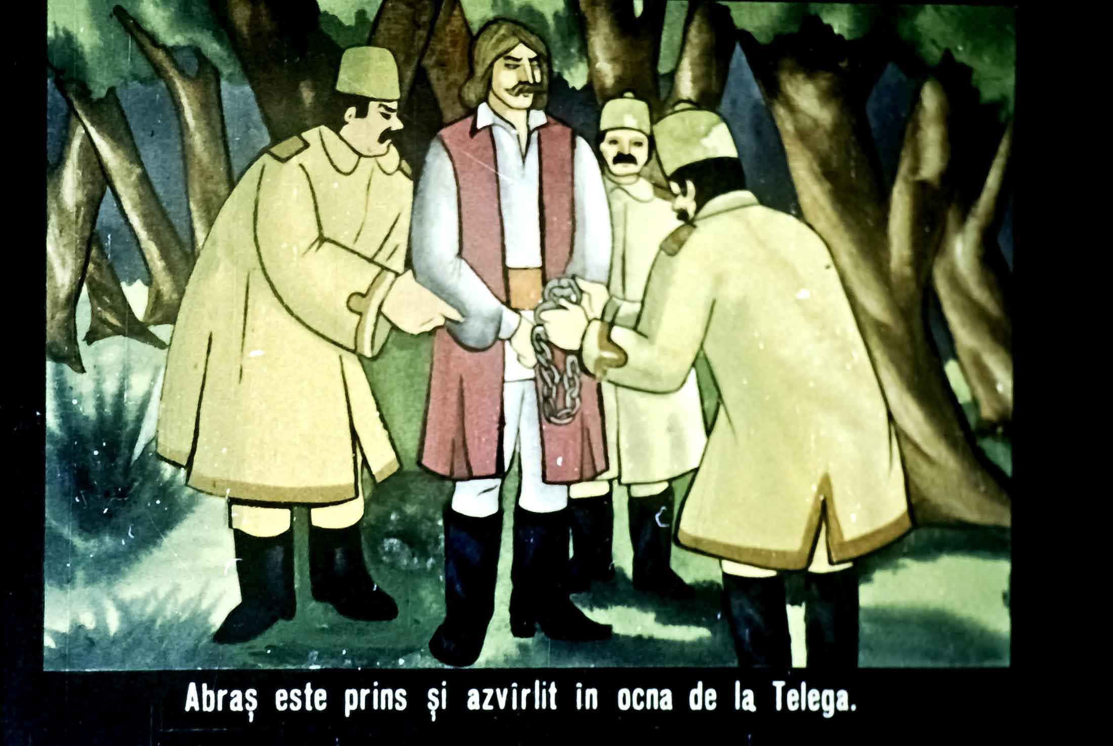 Ilustrație animată cu personaje istorice, una dintre ele fiind prinsă și legată, cu mesaj informativ în partea de jos.