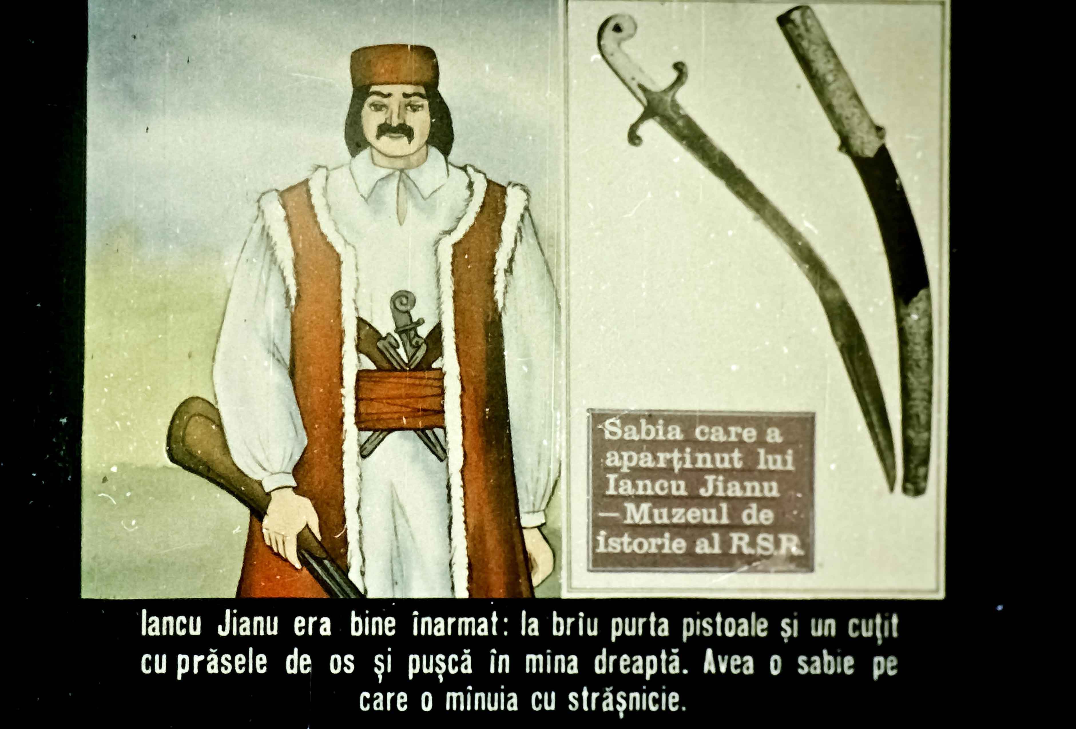 Imaginea prezintă un personaj istoric, Iancu Jianu, înarmat cu o sabie, pistol și cuțit, într-un context cultural specific.