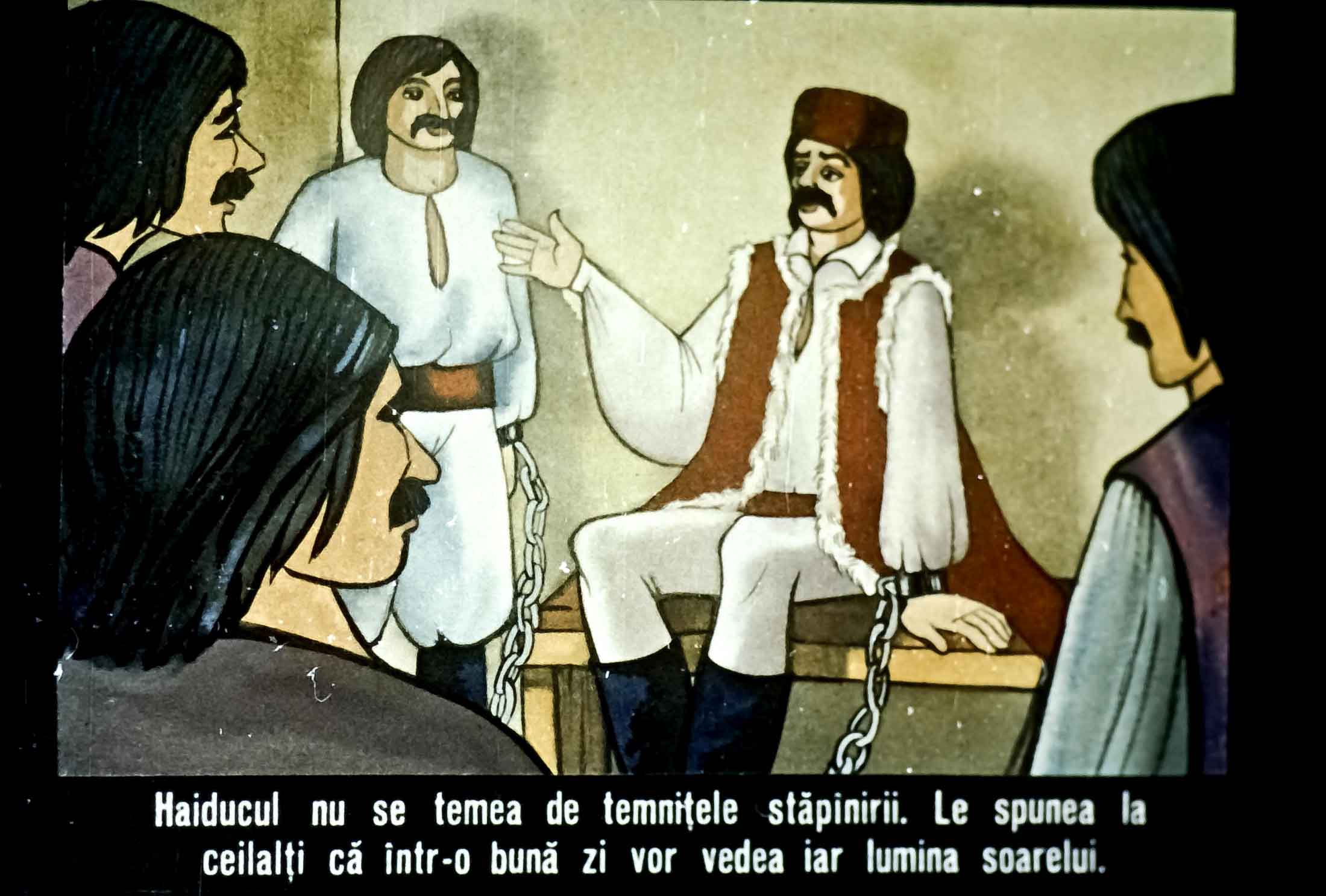 O scenă ilustrată cu un haiduc legat, vorbind cu alții despre curajul său și speranța de a vedea din nou soarele.